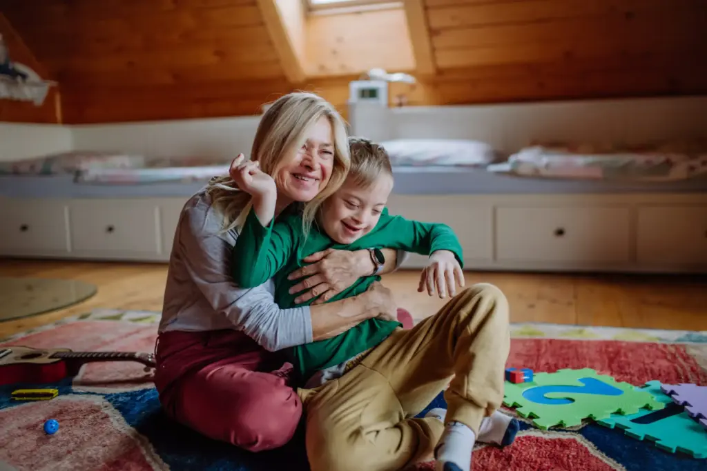 woman hugging her young grandson who has down syndrome