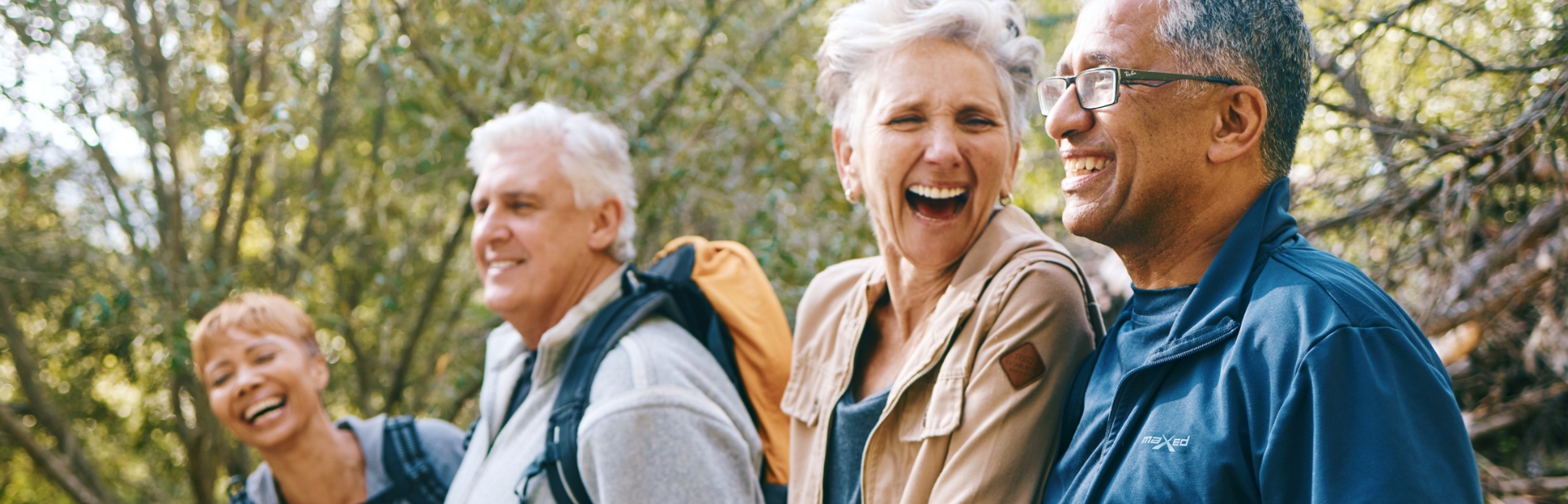 retired couples laughing together on a hike