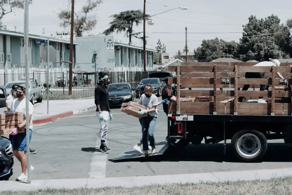 volunteers unloading a truck filled with charitable donations