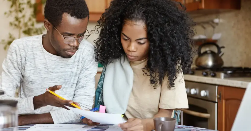 young married couple going through financial documents