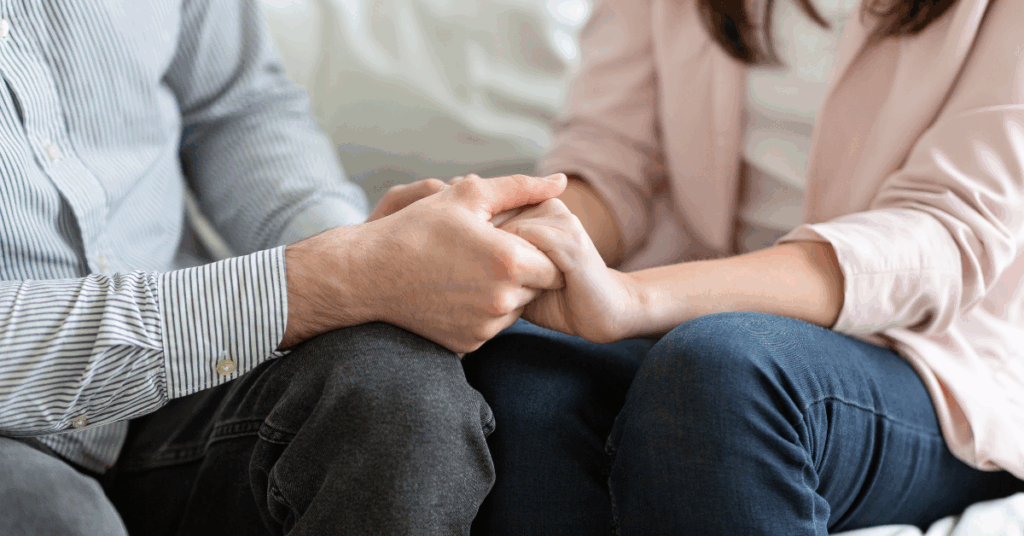 Closeup of a married couple holding hands