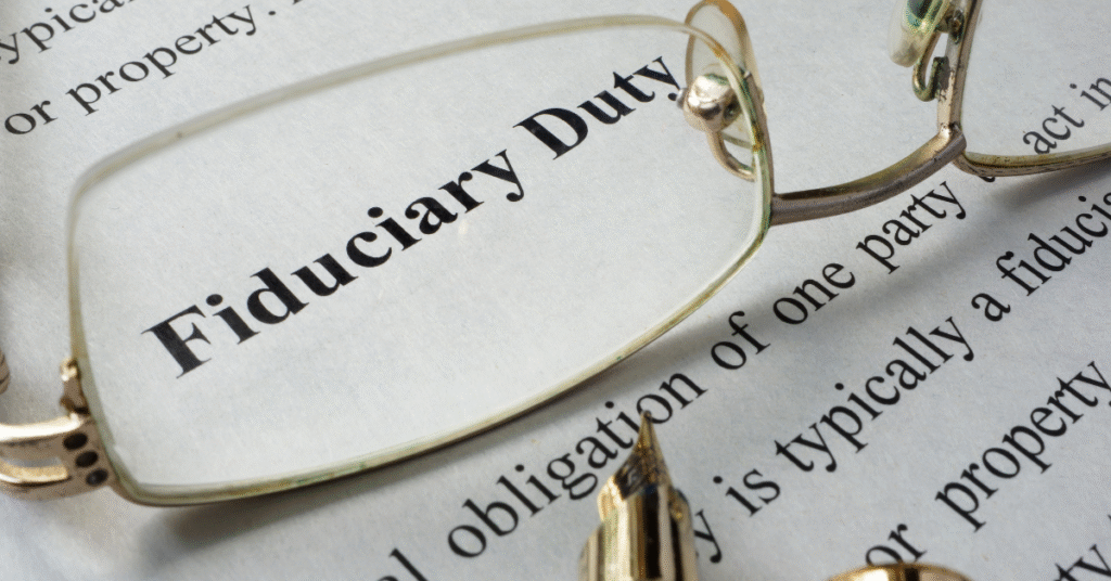 The words "Fiduciary Duty" being highlighted by glasses on a document