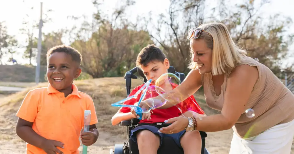 A mother with her two children playing with bubbles.