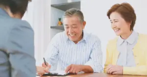 An older couple speaking with a corporate trustee